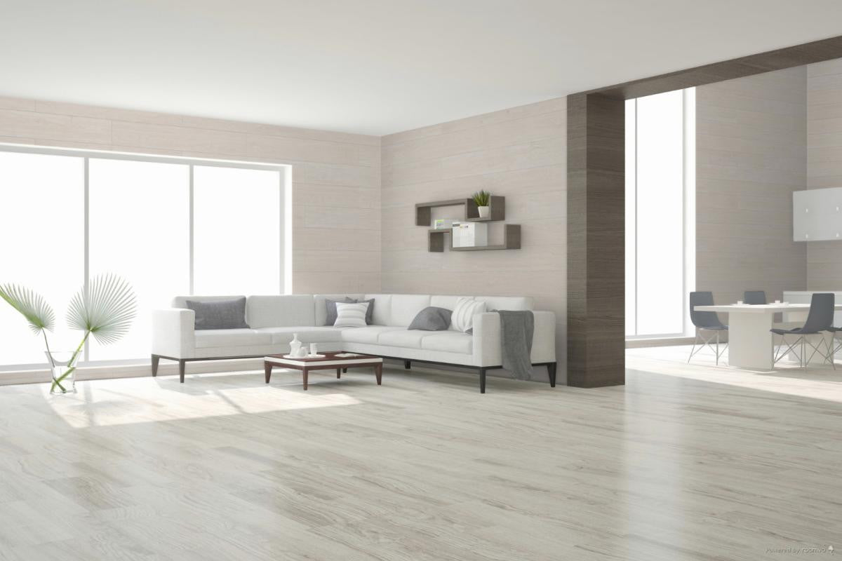 Modern living room with a white sofa, coffee table, porcelain wood look tile floor and decorative elements.