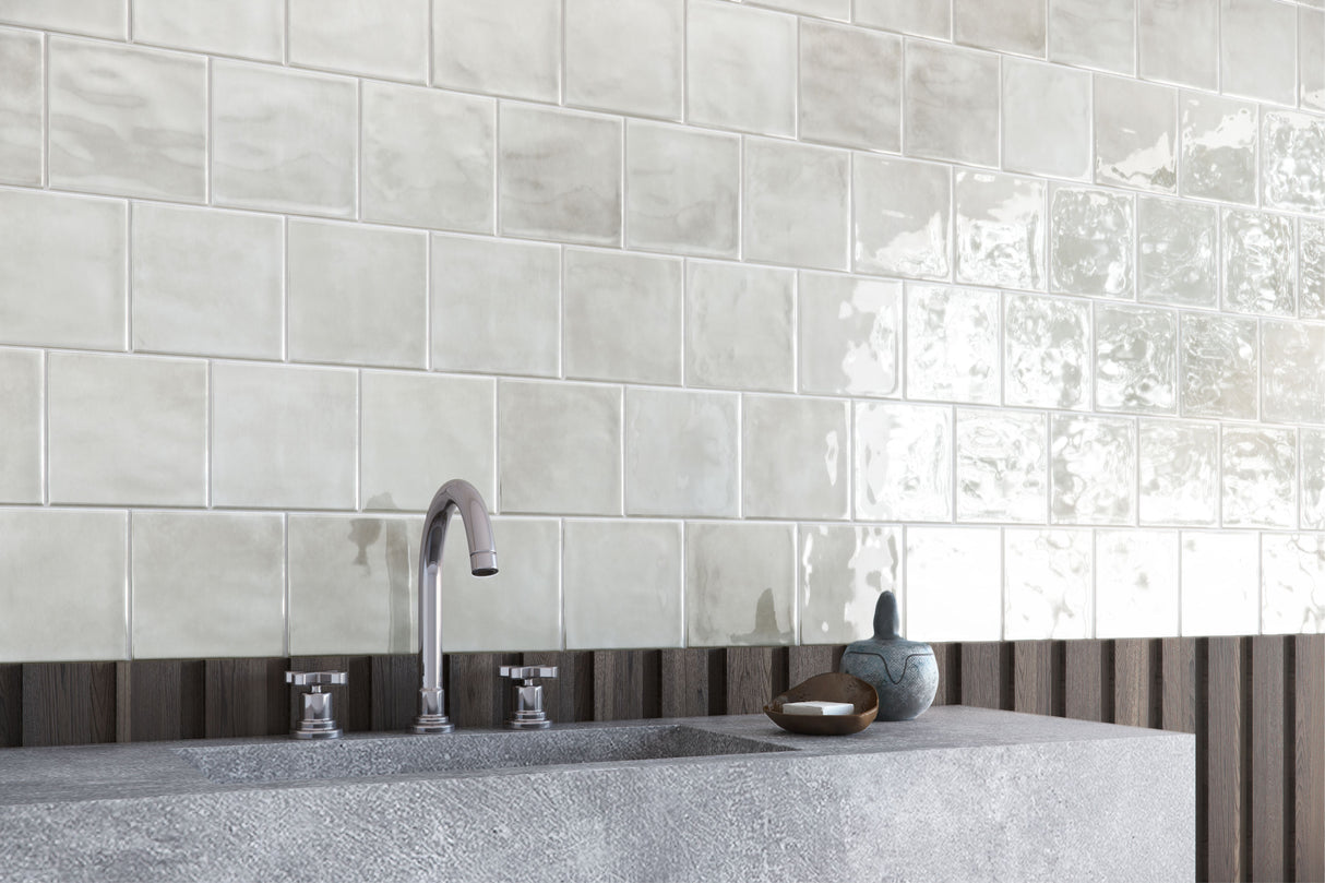 Bathroom with tiled wall, sink, and decorative elements