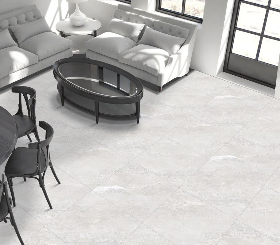 Living room with white tiled floor, gray sofa, and black coffee table.
