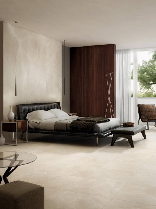 Modern bedroom with a bed, nightstands, and a large window with seamless tile wall and floor from large porcelain slab tile.