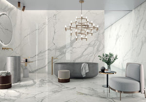 Modern bathroom with marble look porcelain tile walls, a freestanding bathtub, and decorative elements.