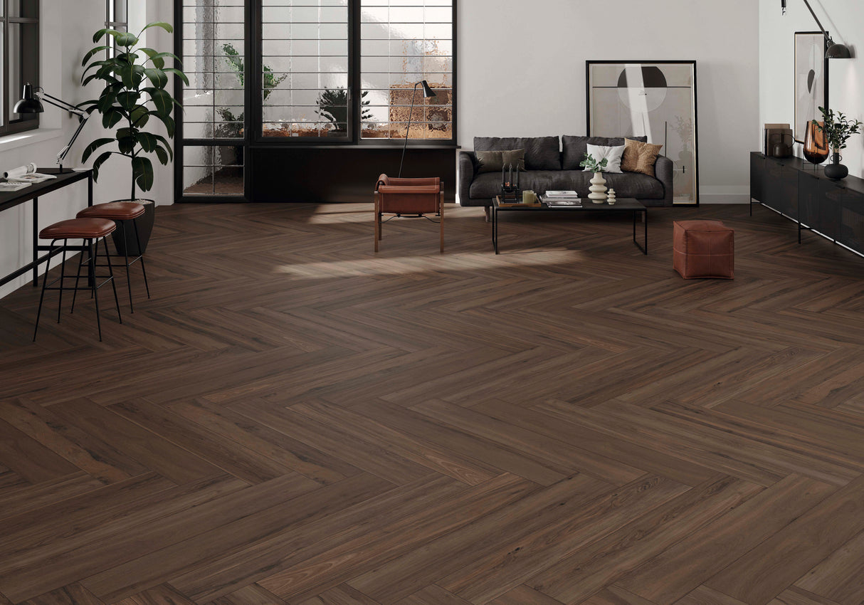 Modern living room with chevron wood-look porcelain tile flooring, furniture, and decor.