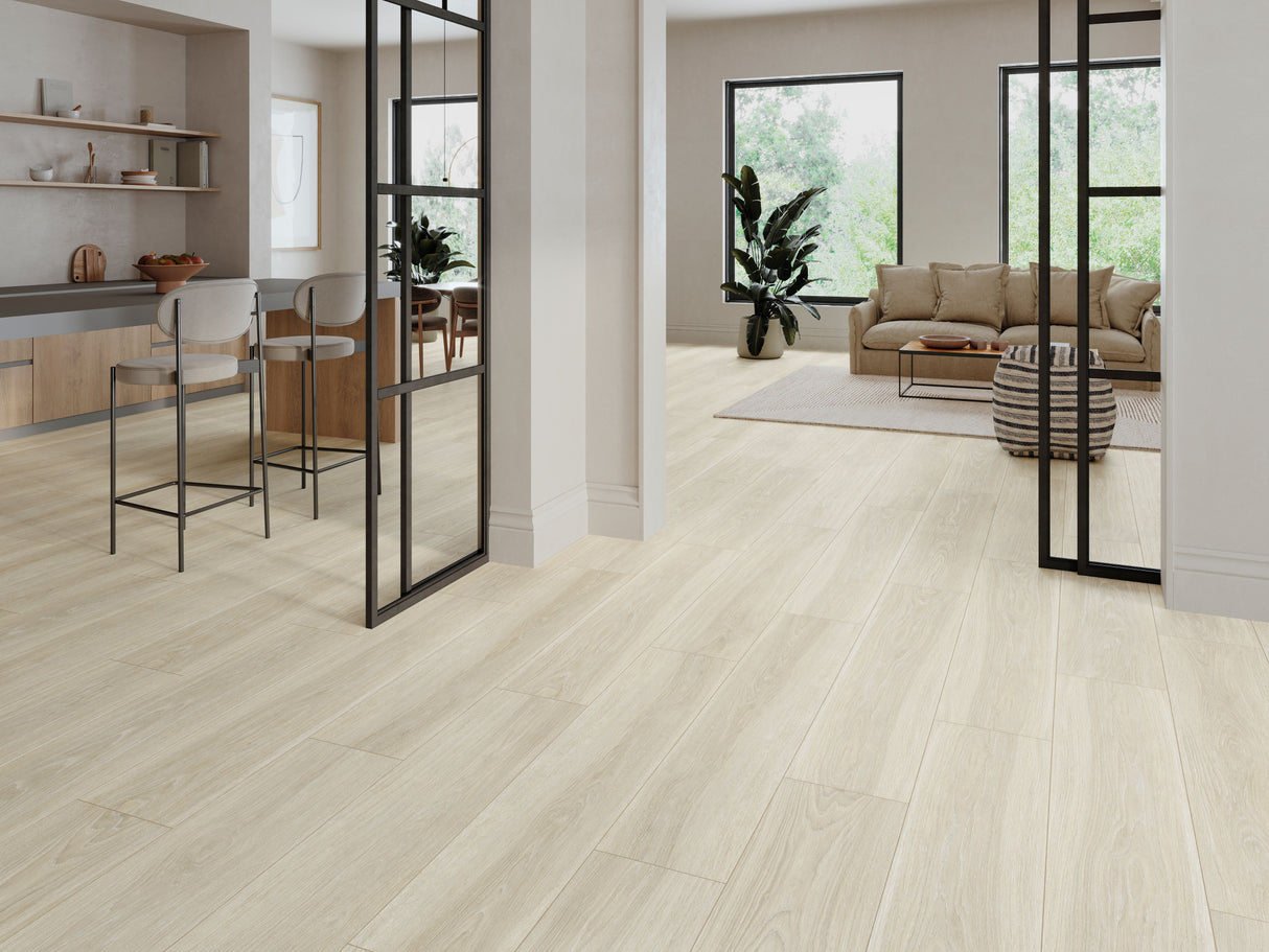 Light beige wood-look tile plank flooring shown in a modern, bright open-plan living space with a kitchen, sofa, and black-framed glass partitions.