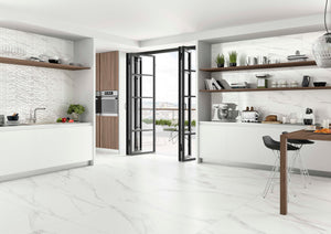 Modern kitchen with white cabinets, marble countertops, and a Spanish ceramic white tile backsplash