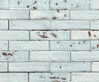 Artesano Cozumel Blue Glossy Brick 2x9 clay tile in a running-bond layout, pale blue crackle glaze with chipped red clay edges