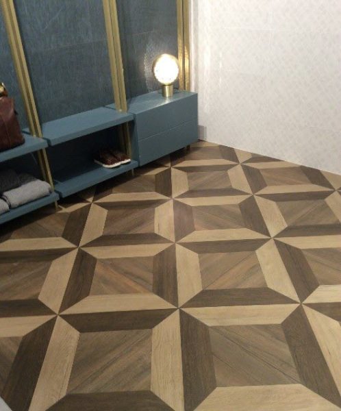 Bold wood plank tile designs that look like parquet looks – flooring composed of wooden blocks arranged in a geometric pattern.