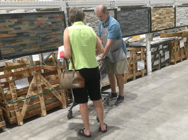 Dennis Werley, employee-owner of Tile Outlets of America in Fort Myers, helping a customer