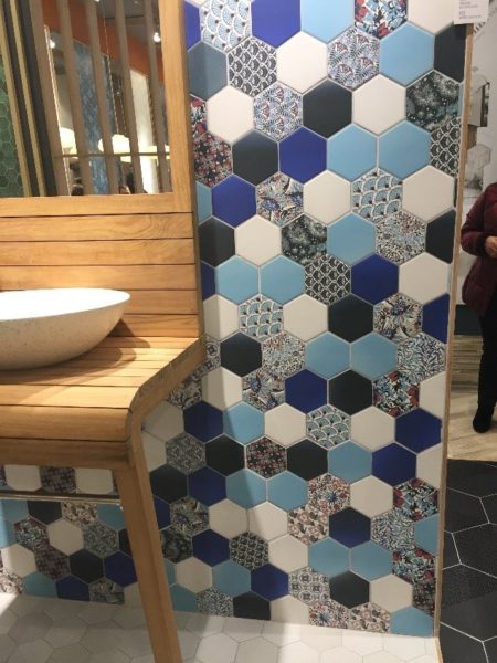 Look at this pattern combining solid shades of blue with small patterns. (Notice the large format hexagon floor tile in the background).